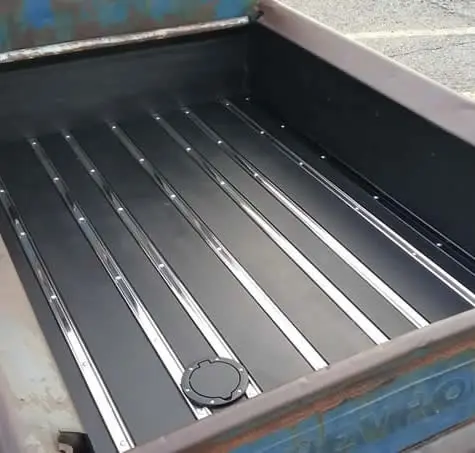 Black interior and blue exterior of a1953 Chevy pickup truck bed