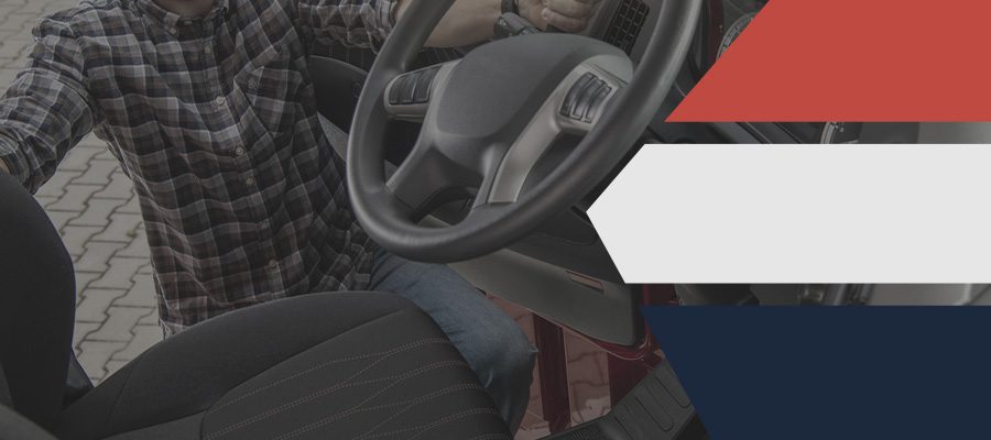 black and gray truck seat covers on display next to a man in a flannel shirt